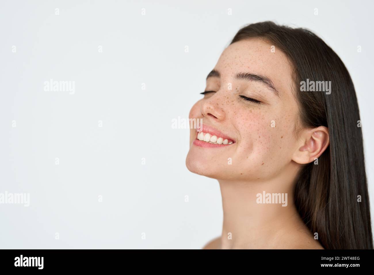 Happy Latin girl with freckles on face isolated on white background. Skin care Stock Photo