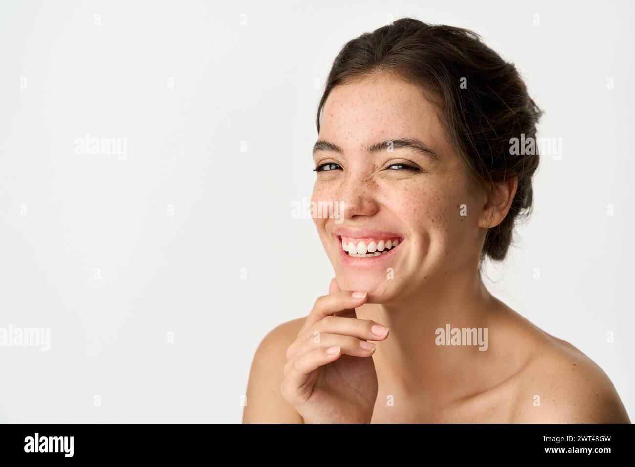 Happy Latin young woman with freckles on face isolated on white. Portrait. Stock Photo