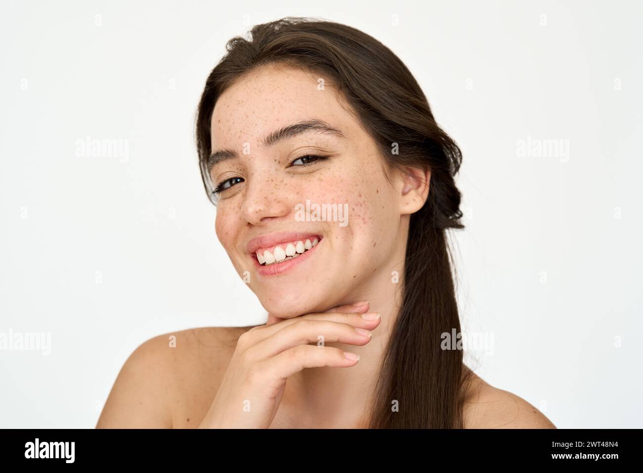 Happy Hispanic young woman with freckles on face isolated on white. Portrait. Stock Photo
