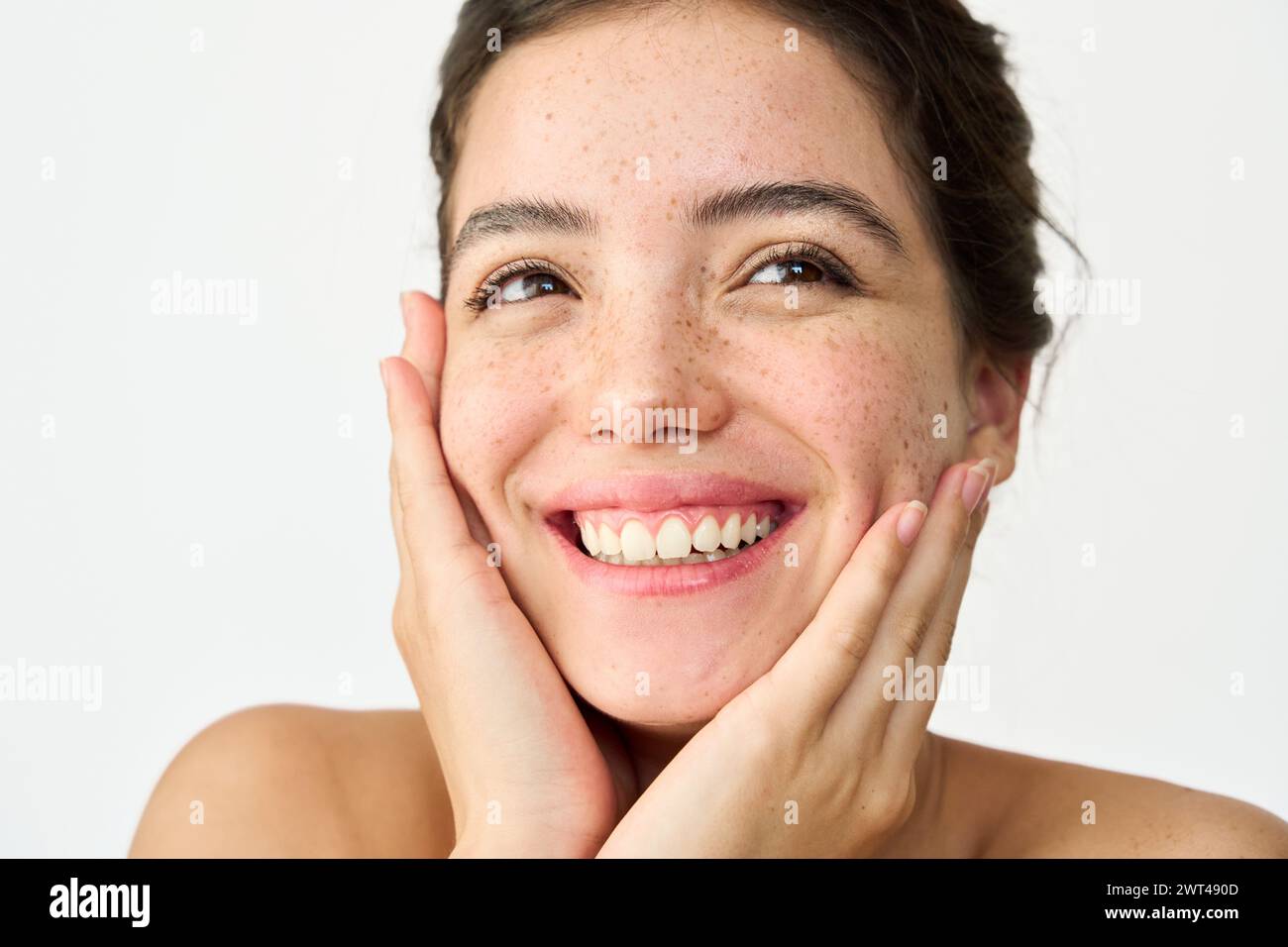 Happy Latin young woman freckled face isolated on white. Close up portrait. Stock Photo