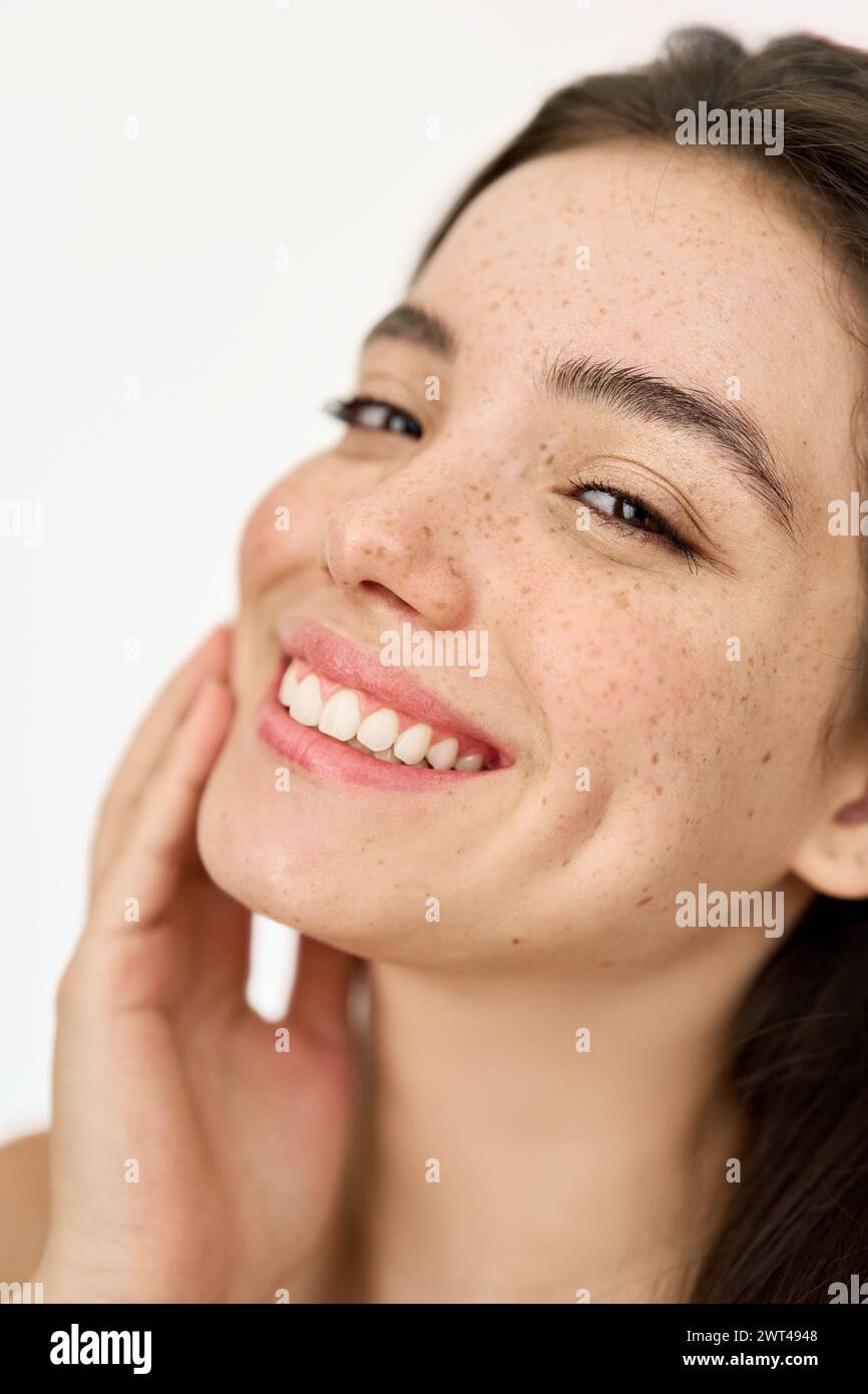 Happy Latin young woman freckled face isolated on white. Vertical portrait. Stock Photo