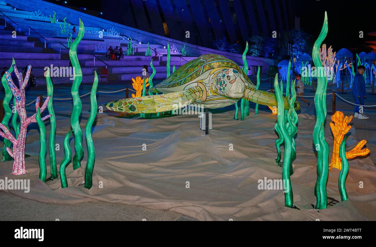 Luminous Festival Lusail 2024 in Lusail Boulevard, Qatar  night shot showing vibrant light displays, fountain with crowds of people watching Stock Photo