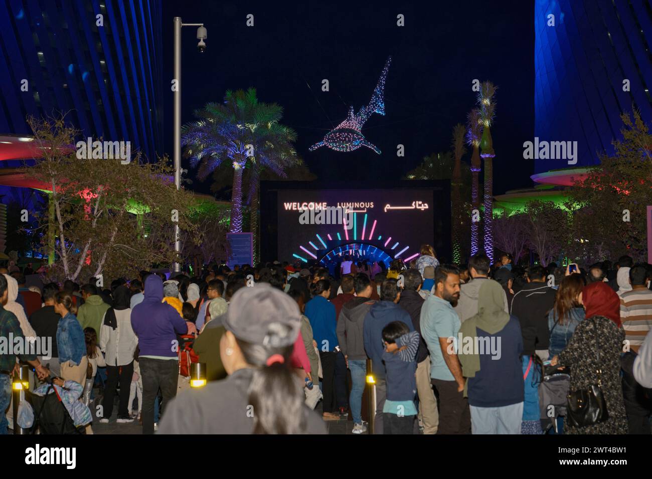 Luminous Festival Lusail 2024 in Lusail Boulevard, Qatar  night shot showing vibrant light displays, fountain with crowds of people watching Stock Photo