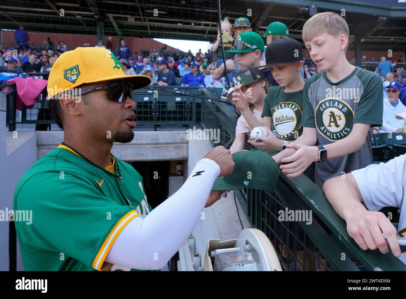 Oakland Athletics shortstop Darell Hernaiz signs autographs for fans