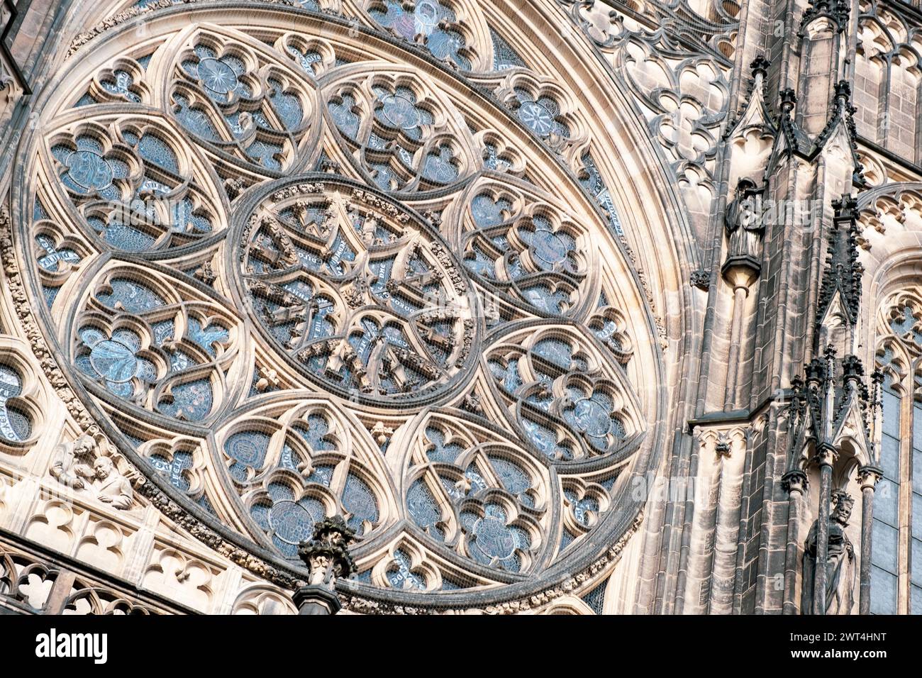 Gothic architecture featuring detailed stone carvings at cathedral entrance during daytime. Prague, Czech Republic Stock Photo