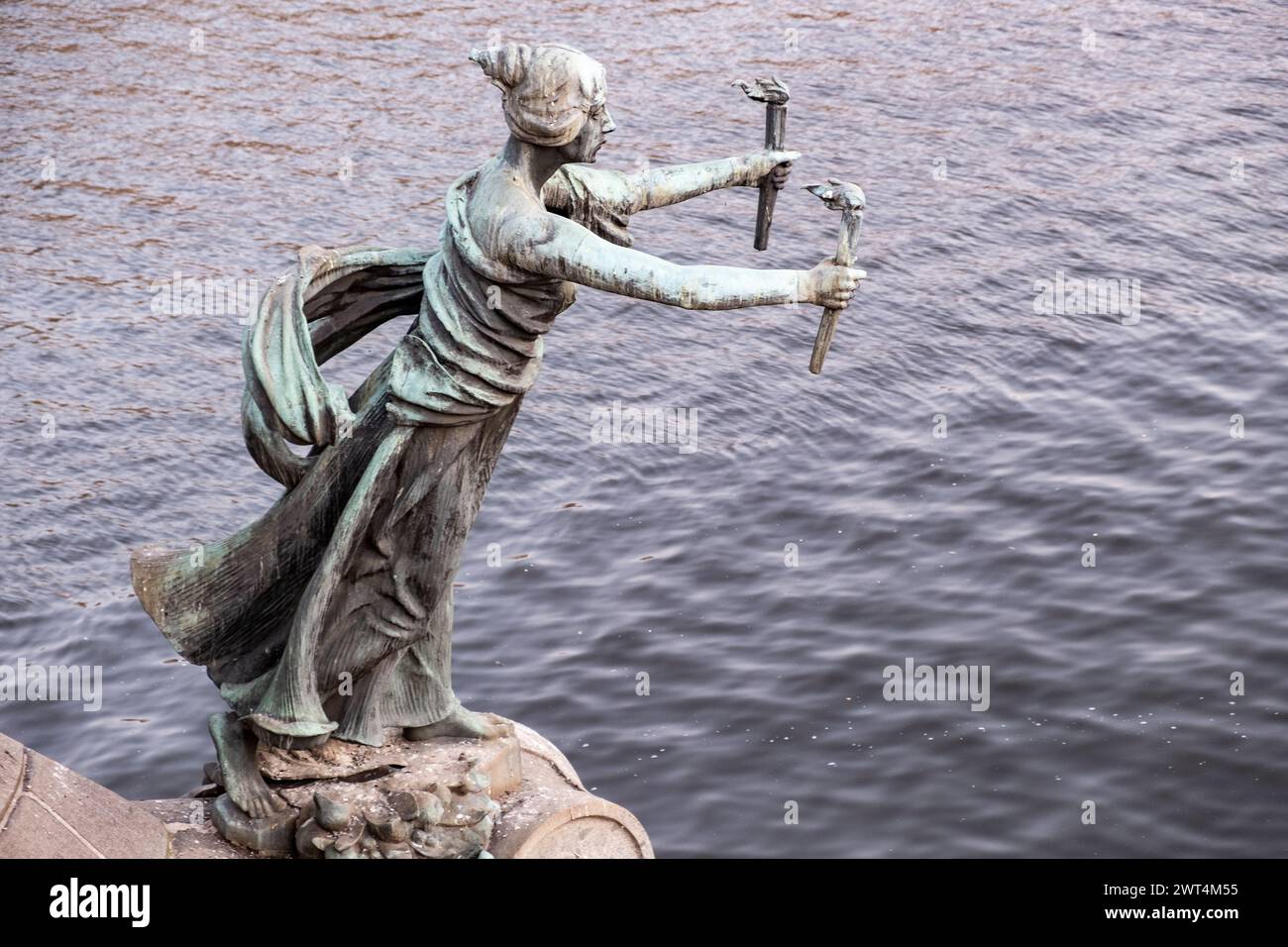 Bronze statue situated on a bridge of Moldova river in summer sunset ...