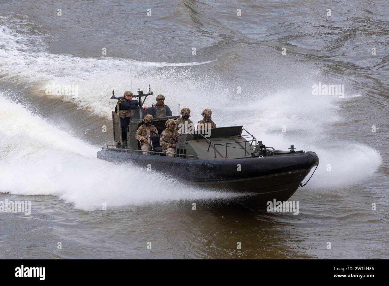 Royal Marines Commandos taking part in Constable's Dues traditional event by the Tower of London, UK. Riding in Offshore Raiding Craft on River Thames Stock Photo