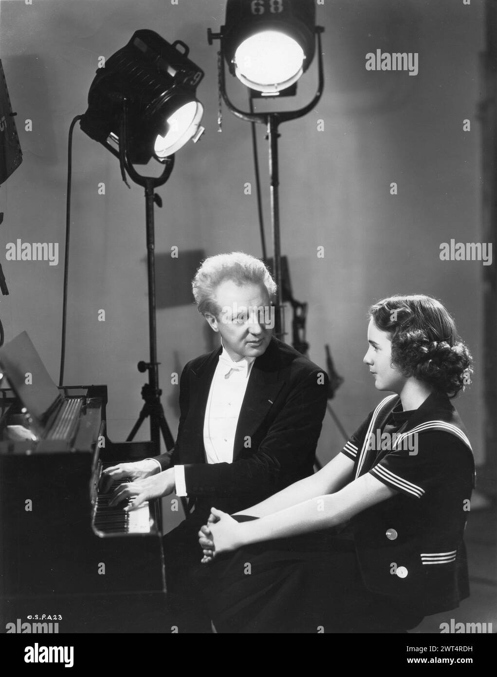 Conductor LEOPOLD STOKOWSKI and DEANNA DURBIN in a publicity photograph for 100 MEN AND A GIRL 1937 Directed by HENRY KOSTER Universal Pictures Stock Photo