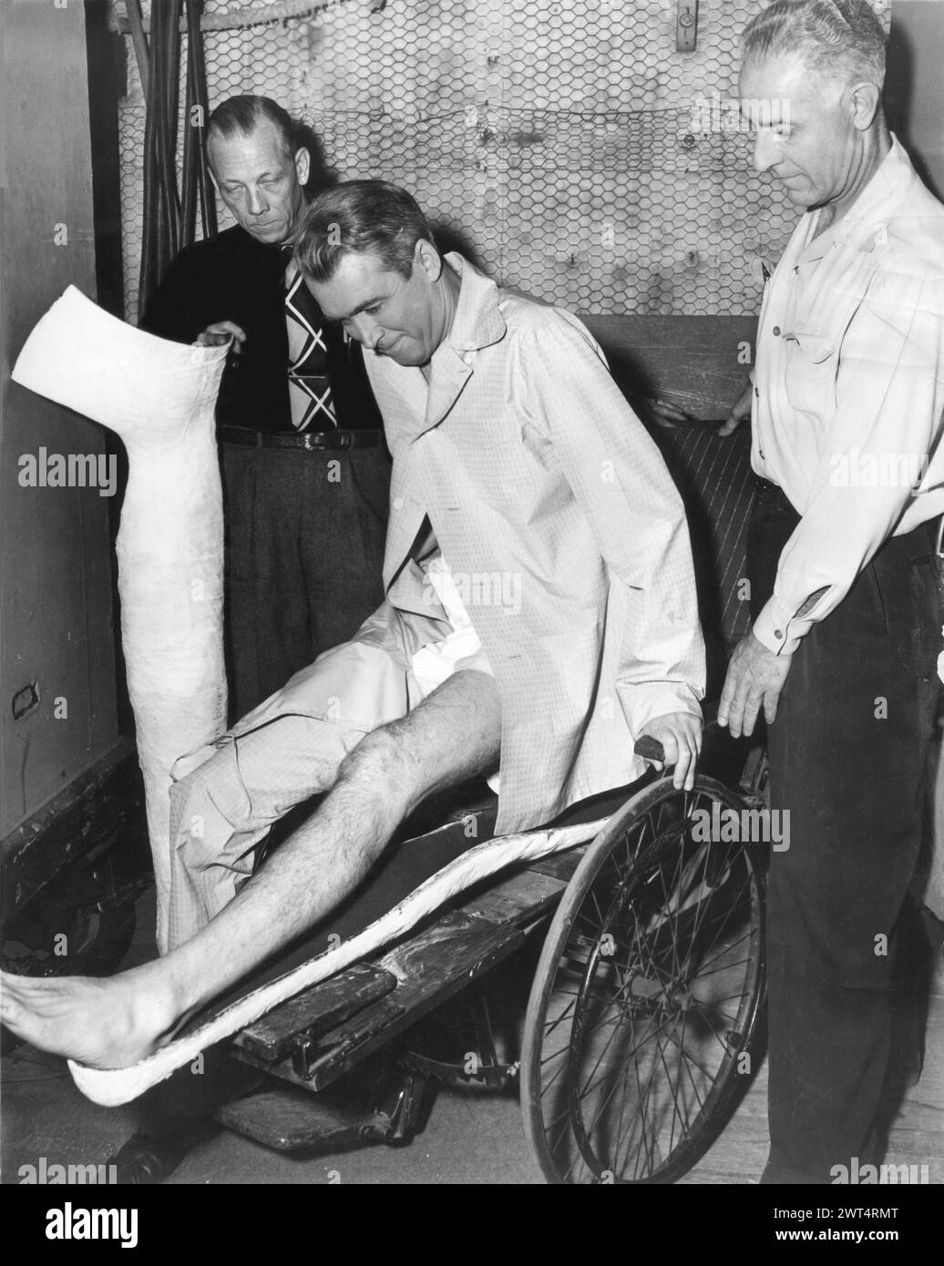 American Film Actor JAMES STEWART being fitted with plaster make-up on his leg for his role in REAR WINDOW 1954 Director ALFRED HITCHCOCK Writer JOHN MICHAEL HAYES Costume Design EDITH HEAD Music FRANZ WAXMAN Paramount Pictures Stock Photo