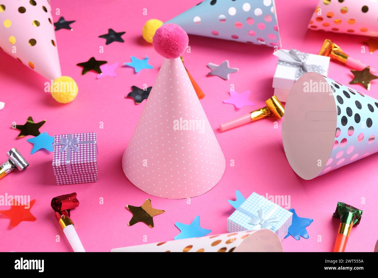 Party hats and other bright decor elements on pink background Stock ...