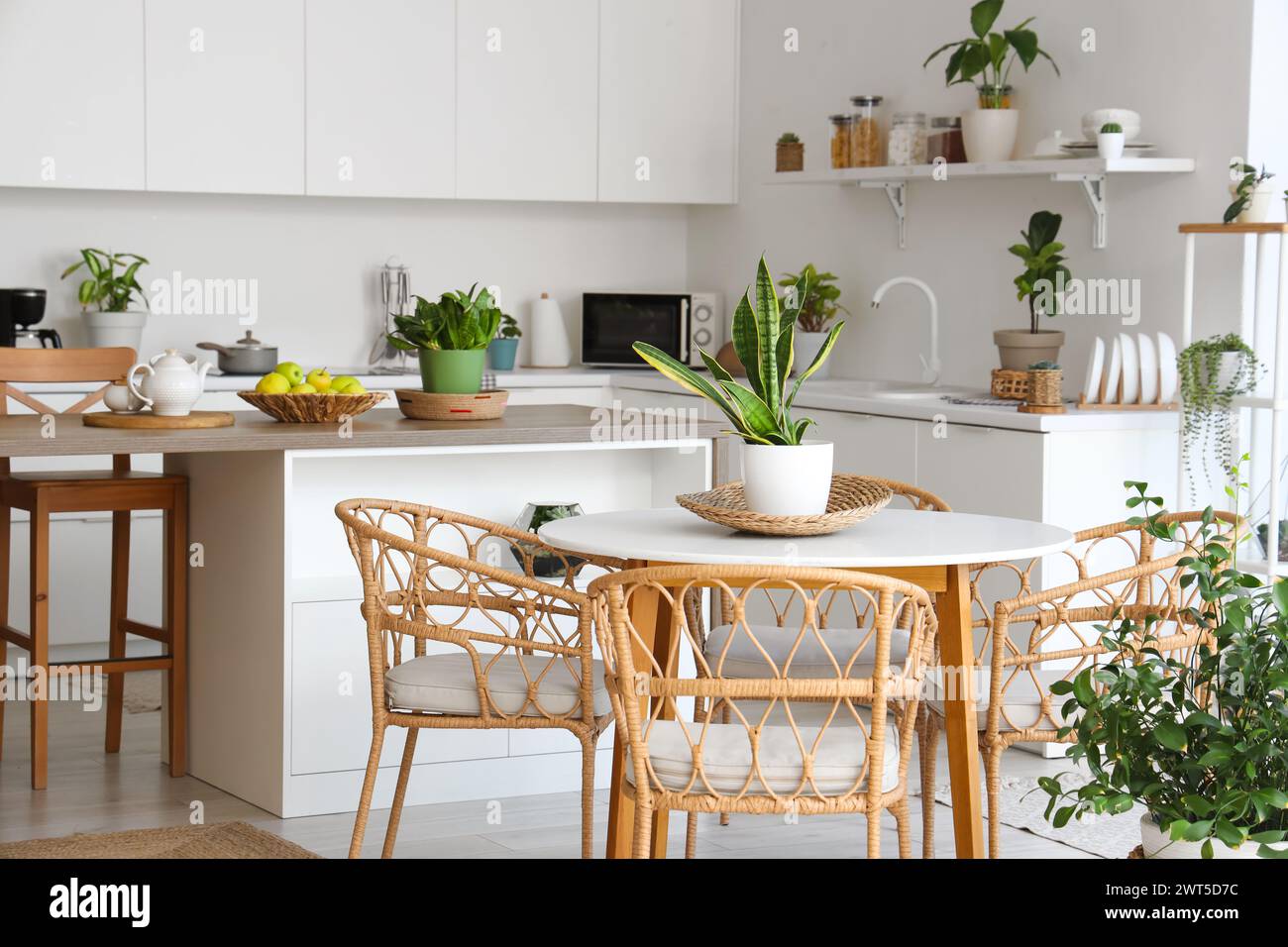 Stylish interior of modern kitchen with armchairs, dining table ...