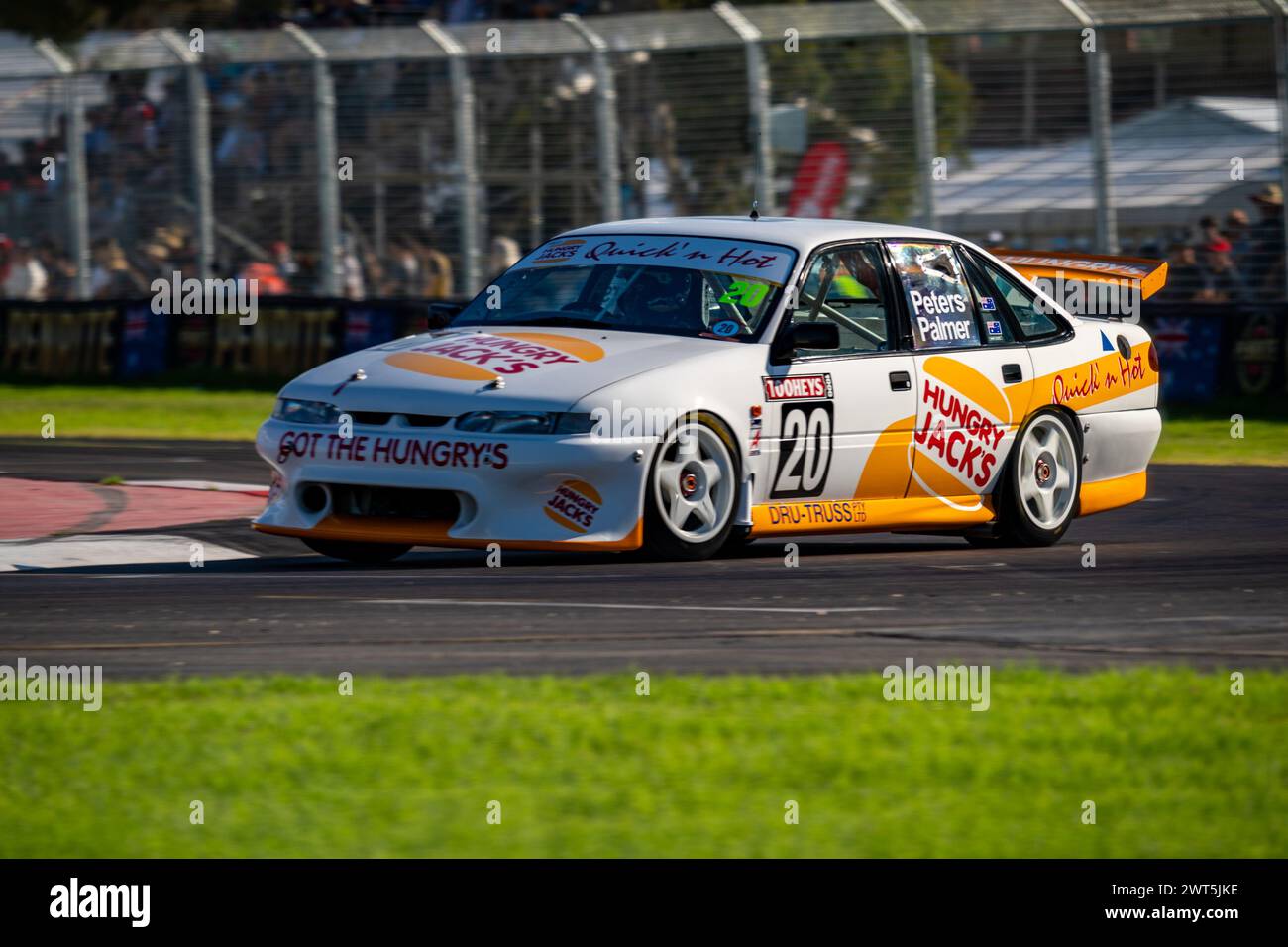 Adelaide, Australia. 16 March, 2024. The Hungry Jacks commodore (#20) turns into the final corner on Saturday at the 2024 Repco Adelaide Motorsport Festival. Credit: James Forrester/Alamy Live News Stock Photo