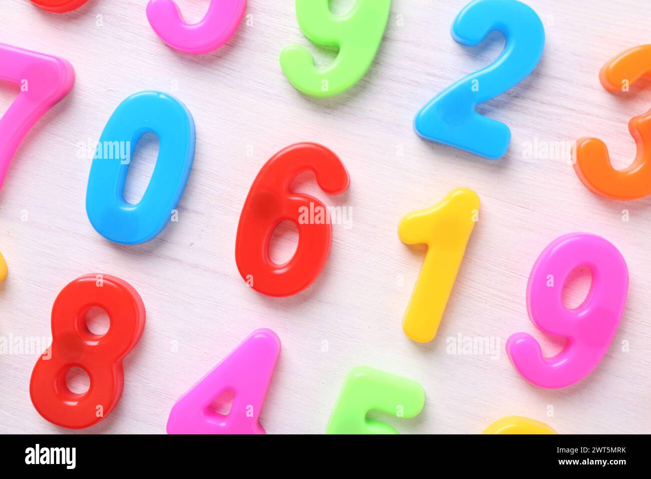 Colorful numbers on white wooden school desk, flat lay Stock Photo - Alamy