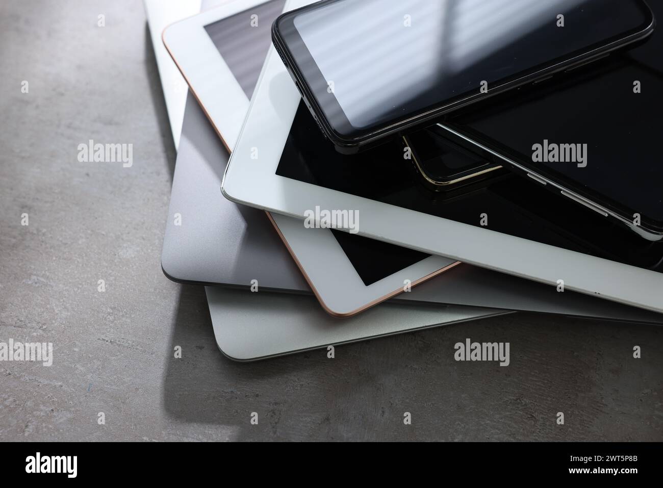 Many different modern gadgets on grey table, closeup Stock Photo