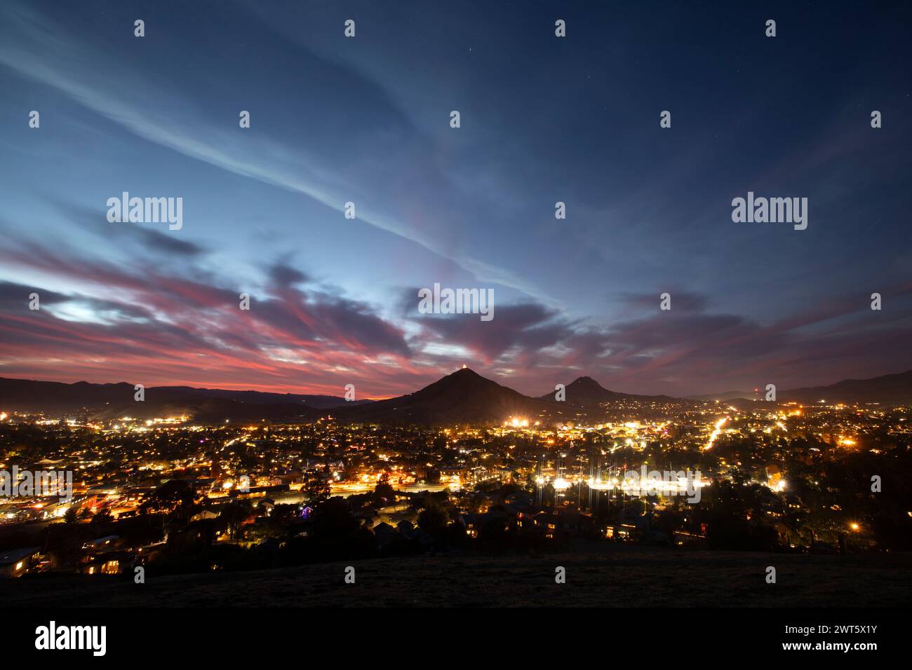 Beautiful elevated twilight sunset view of the evening lights of downtown San Luis Obispo, California, USA. Stock Photo