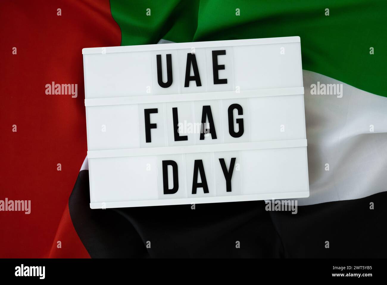Lightbox with text UAE FLAG DAY on United Arab Emirates waving flag ...
