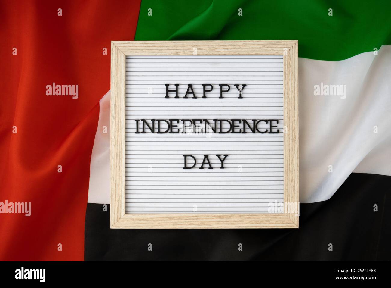 HAPPY INDEPENDENCE DAY text frame on United Arab Emirates waving flag ...
