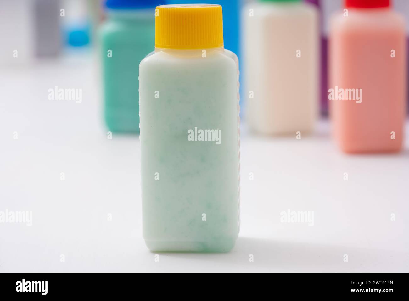 Plastic bottle with green liquid. Samples of food colouring in a food ...