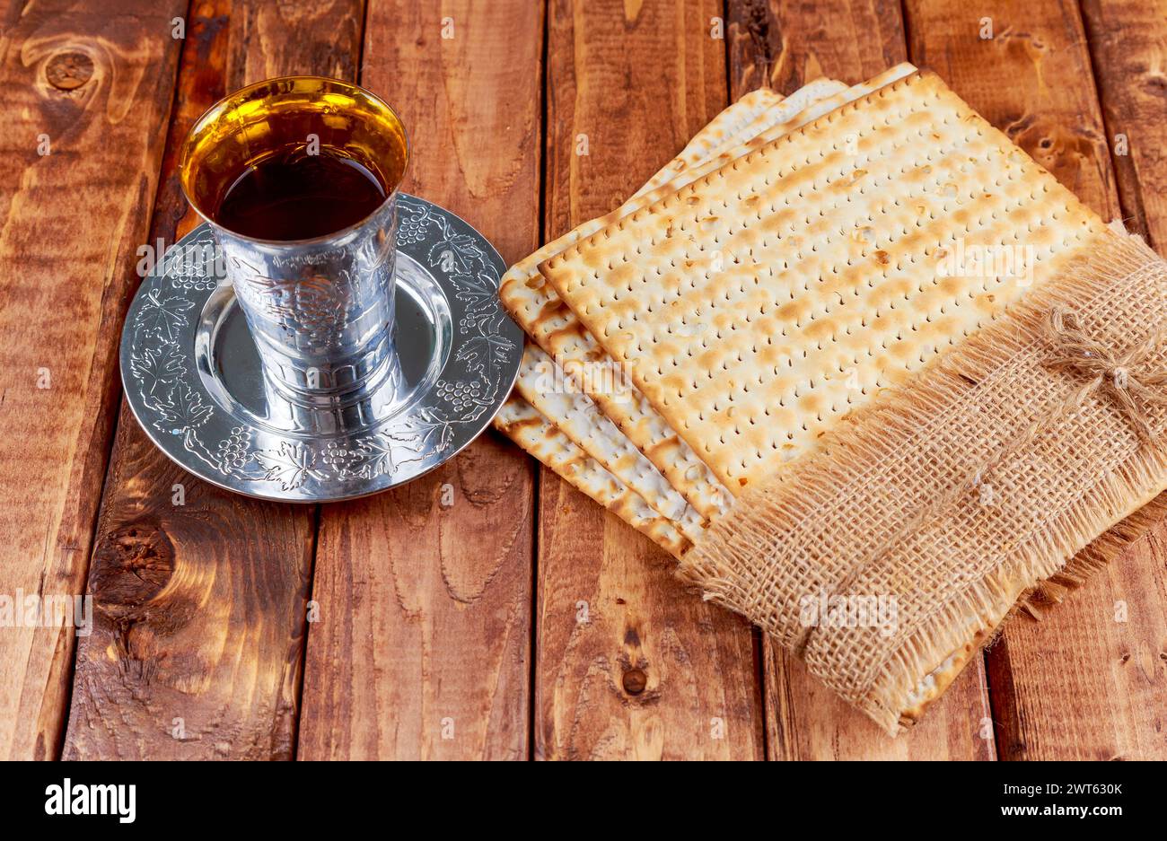 Red kosher wine unleavened bread matzo with Pesach story of exodus is retold reverence solemnity. Stock Photo