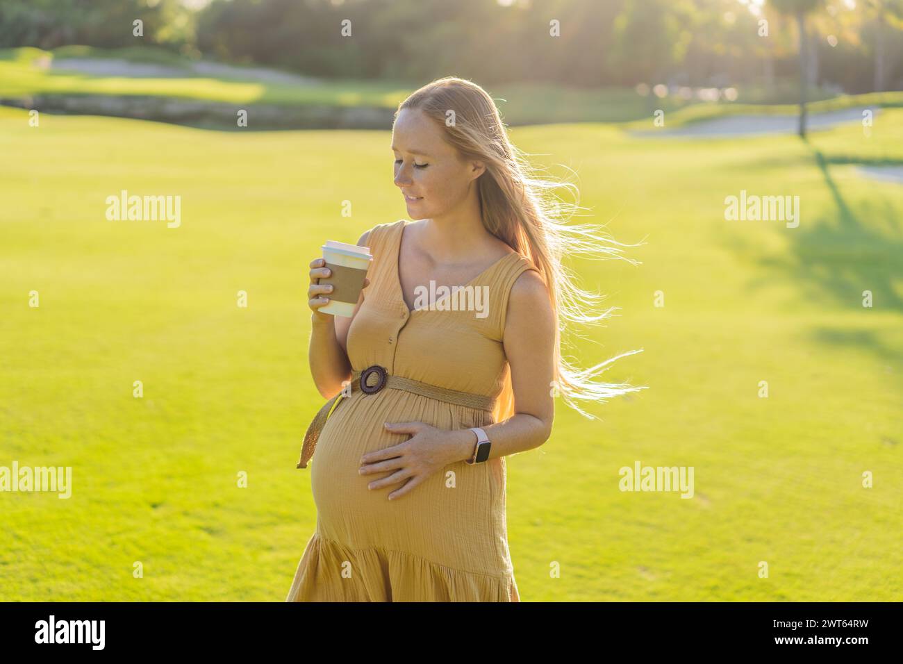 pregnant woman enjoys a cup of coffee outdoors, blending the simple pleasures of nature with the