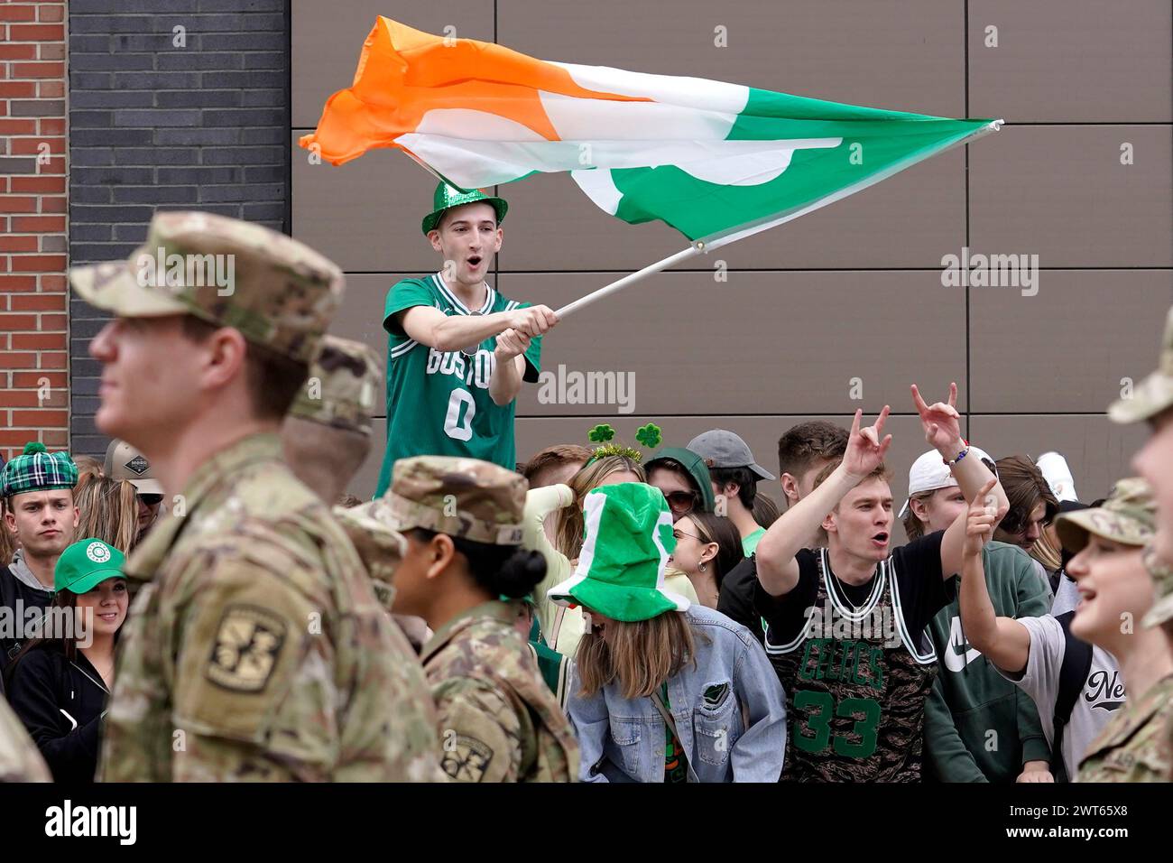 FILE - A spectator, top, waves a flag that features a likeness of a ...