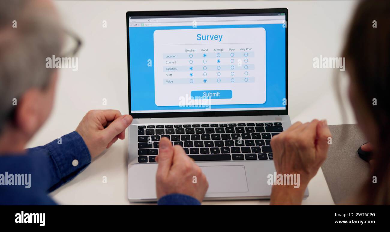 Filling Customer Survey Online Electronic Form On Laptop Screen Stock Photo