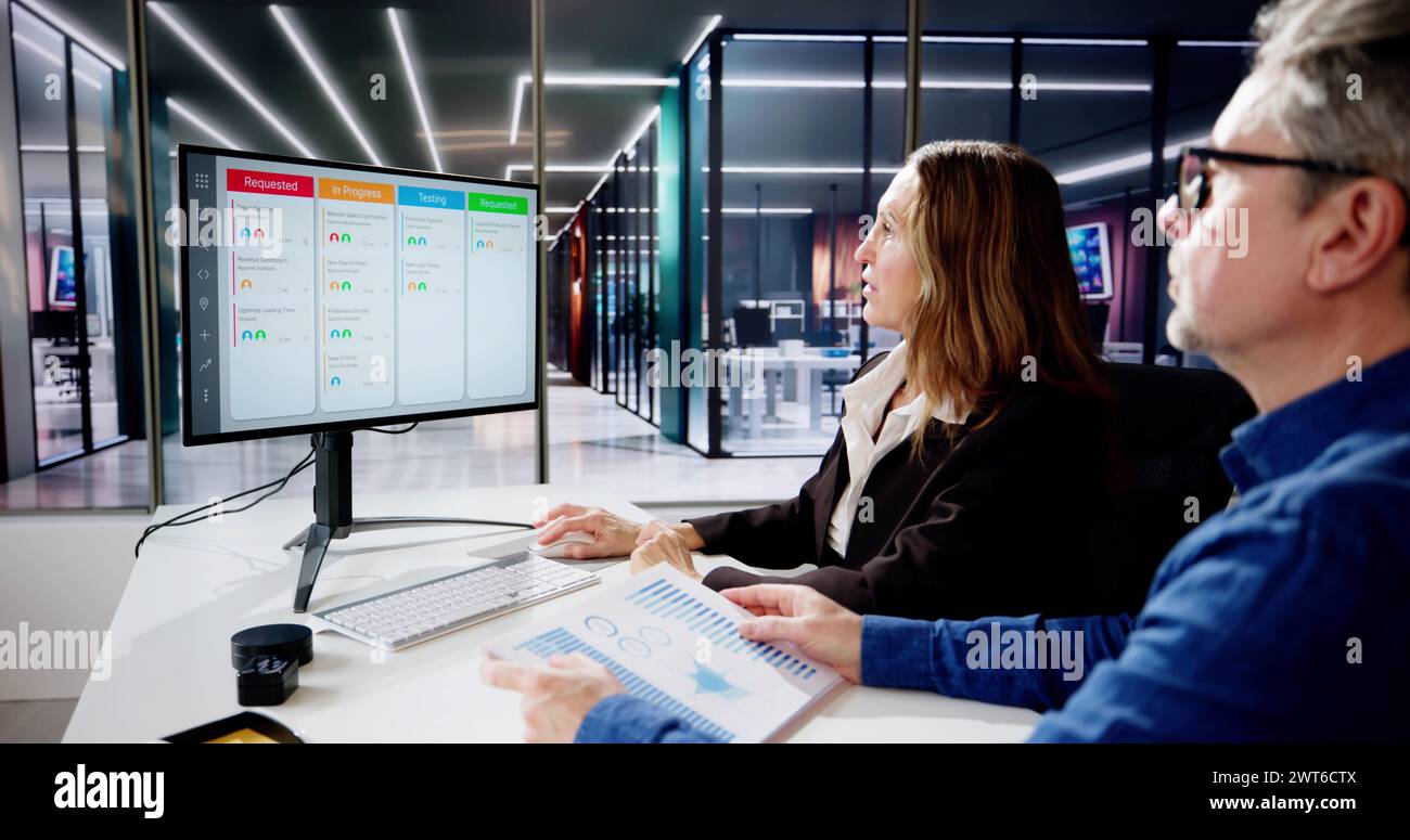 Scrum Project Manager Using Scrum Board Scheduling Software Stock Photo