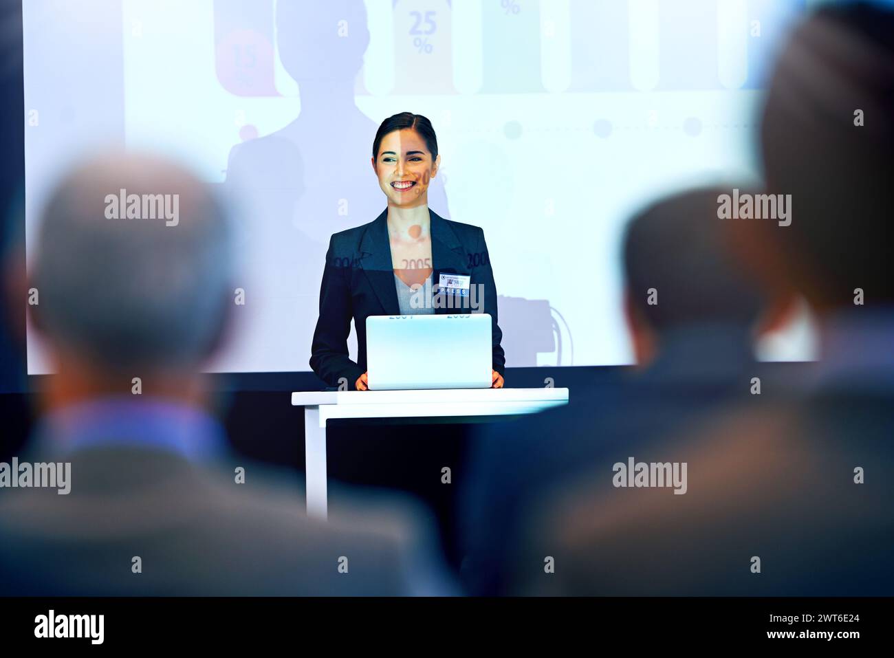 Business woman, smile and presentation with projector screen, conference or workshop with laptop for slideshow. Corporate training, seminar and Stock Photo