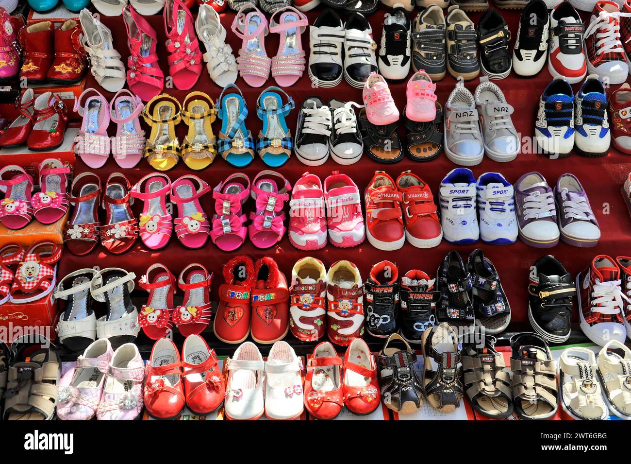 Colourful children's shoe collection presented on a market stall, Kathmandu Valley. Kathmandu, Nepal Stock Photo