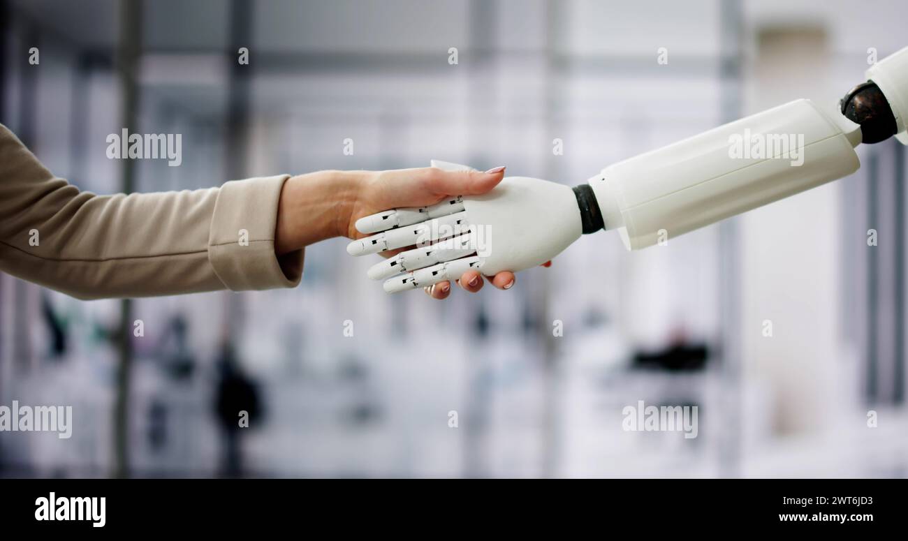 AI Robot And Human Woman Hand Handshake Stock Photo