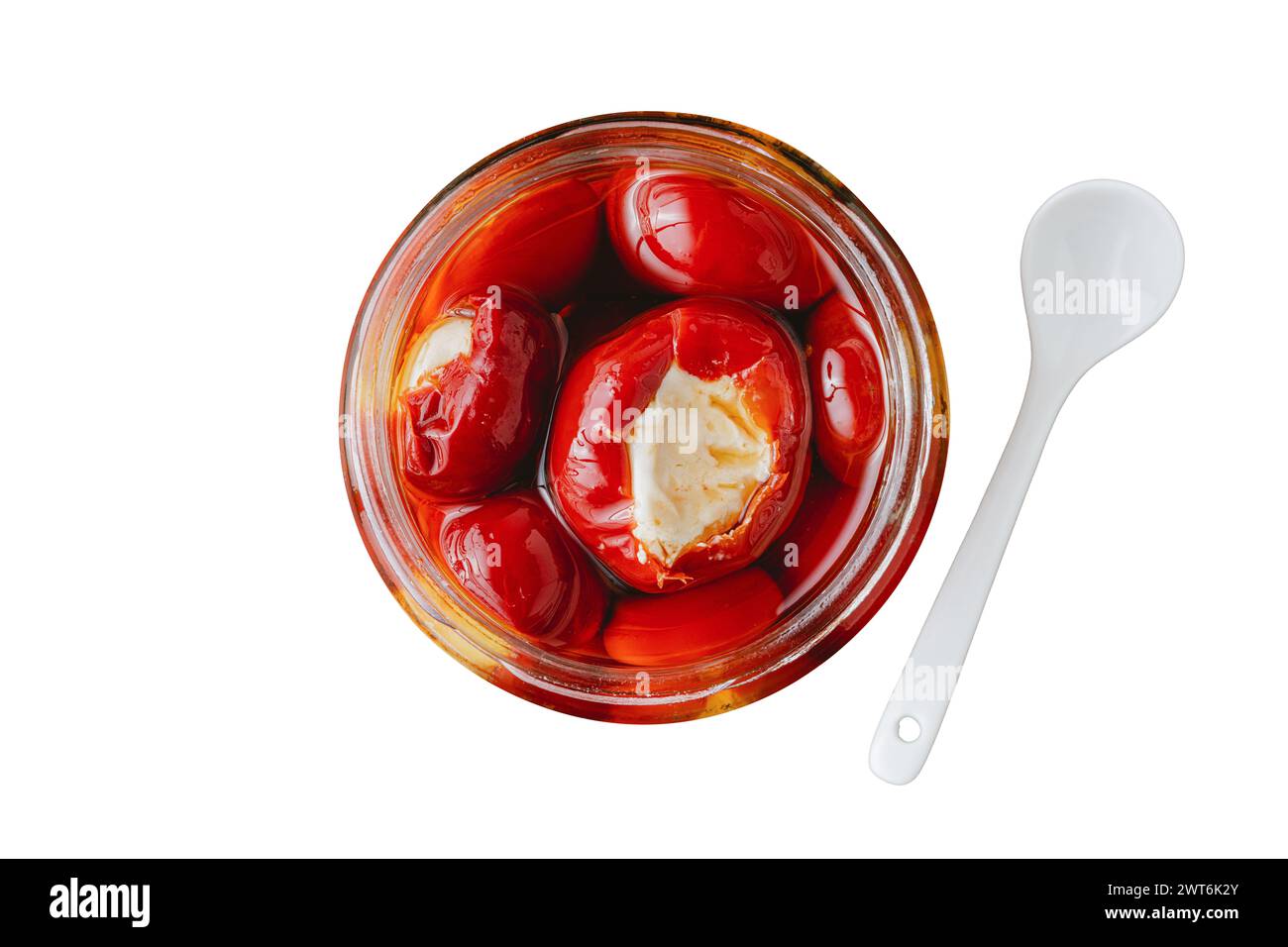 Stuffed cherry peppers with ricotta cheese filling in glass jar on white background Stock Photo