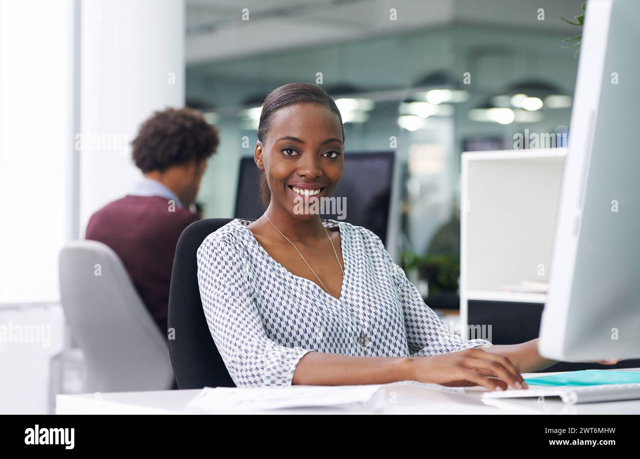 African woman, portrait and computer in office with smile, typing and ...