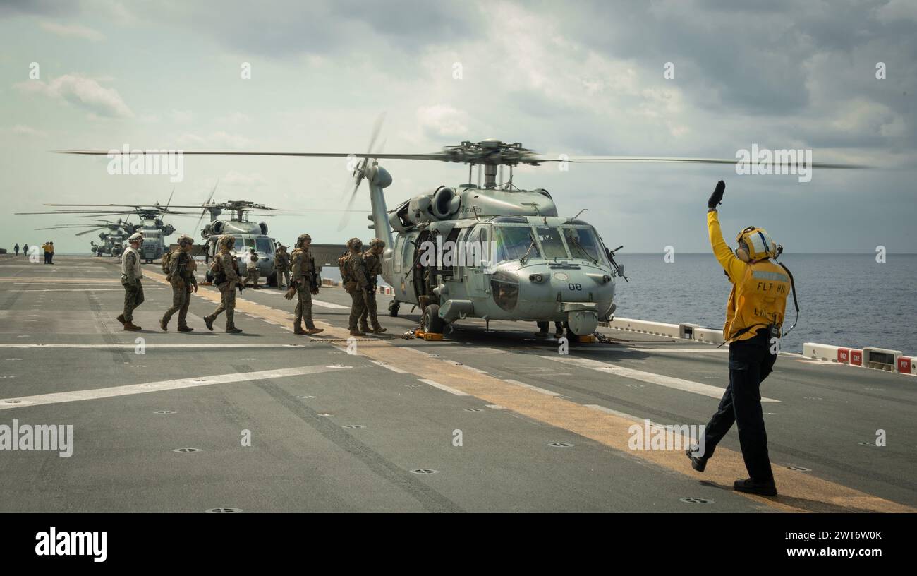 EAST CHINA SEA (Mar. 9, 2024) Aviation Boatswain’s Mate (Handling) 3rd Class Ashley Oscar, right, from Atlanta, assigned to the forward-deployed amphi Stock Photo