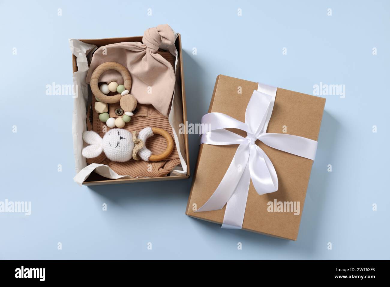 Different baby accessories in box on light blue background, flat lay Stock Photo