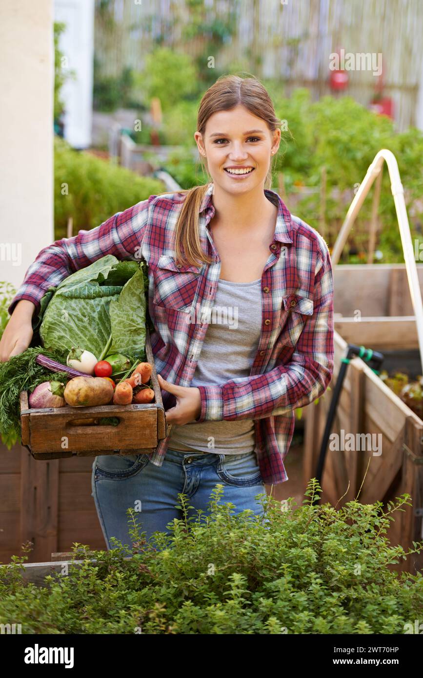 Happy woman, portrait and farmer with box of vegetables in garden or ...