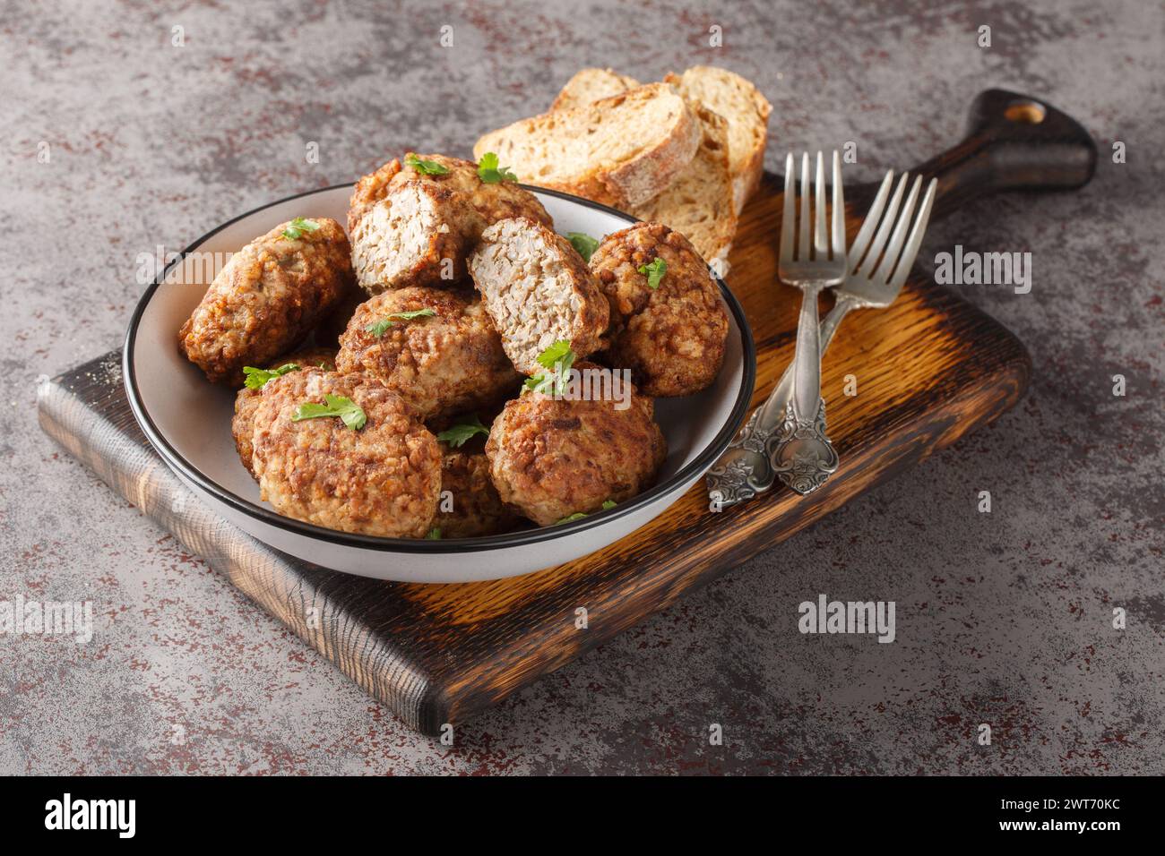 Hrechanyky or Buckwheat meatballs made of minced beef and boiled buckwheat porridge close-up in a plate on the table. Horizontal Stock Photo