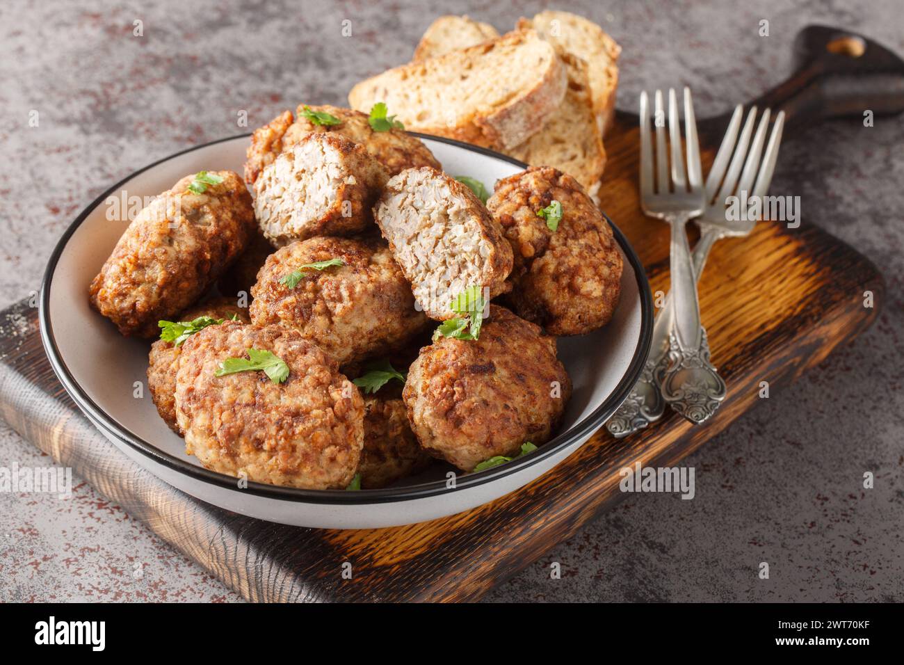 Dietary Buckwheat meatballs made of minced beef and boiled buckwheat porridge with onions, spices close-up in a plate on the table. Horizontal Stock Photo