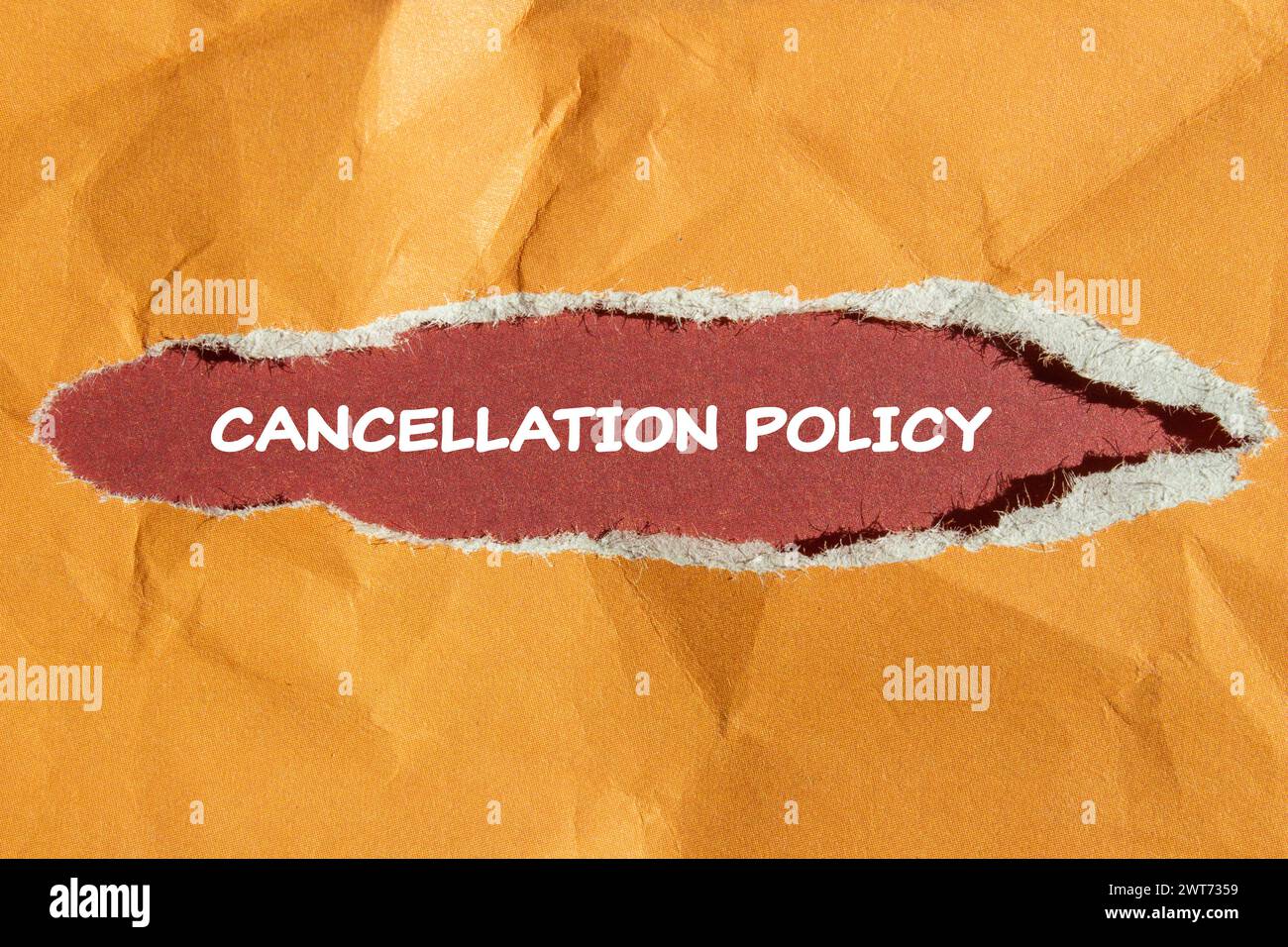 Cancellation policy words written on orange torn paper with red background. Conceptual symbol. Copy space. Stock Photo