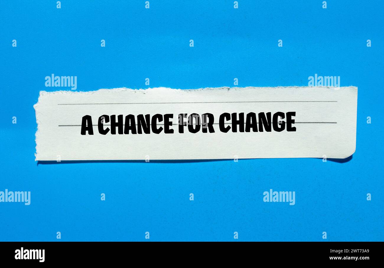 A chance for change words written on torn paper piece with blue ...
