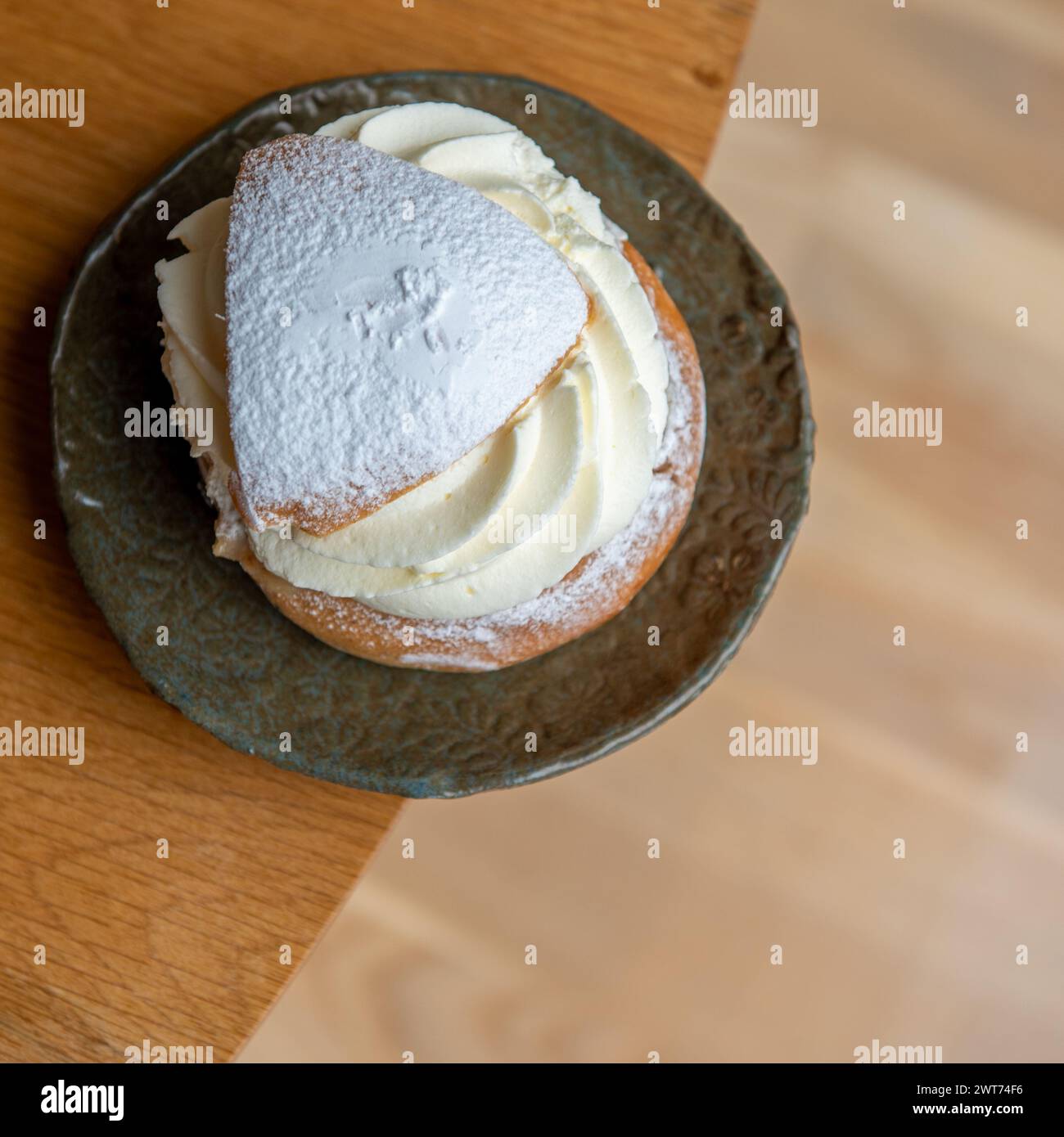 Typical Swedish semla with sweet cream on the table. Stock Photo