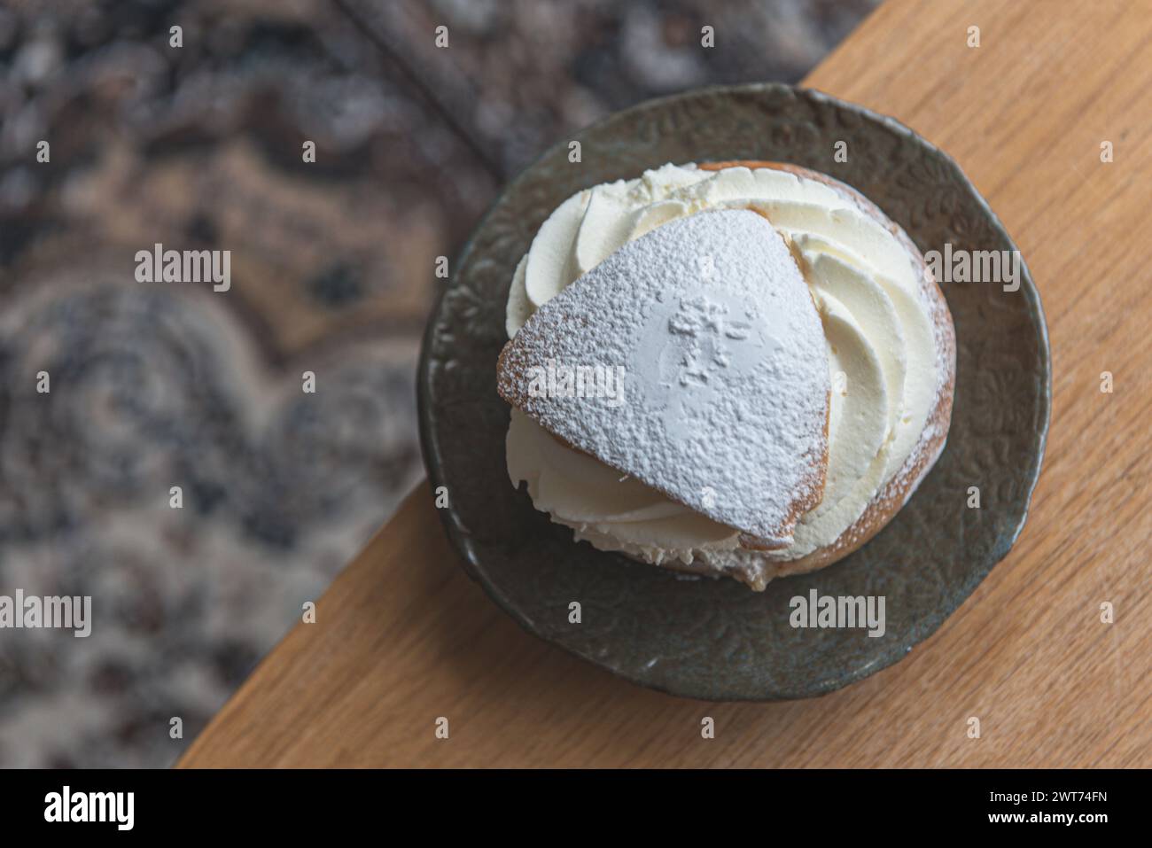 Typical Swedish semla with sweet cream on the table. Stock Photo