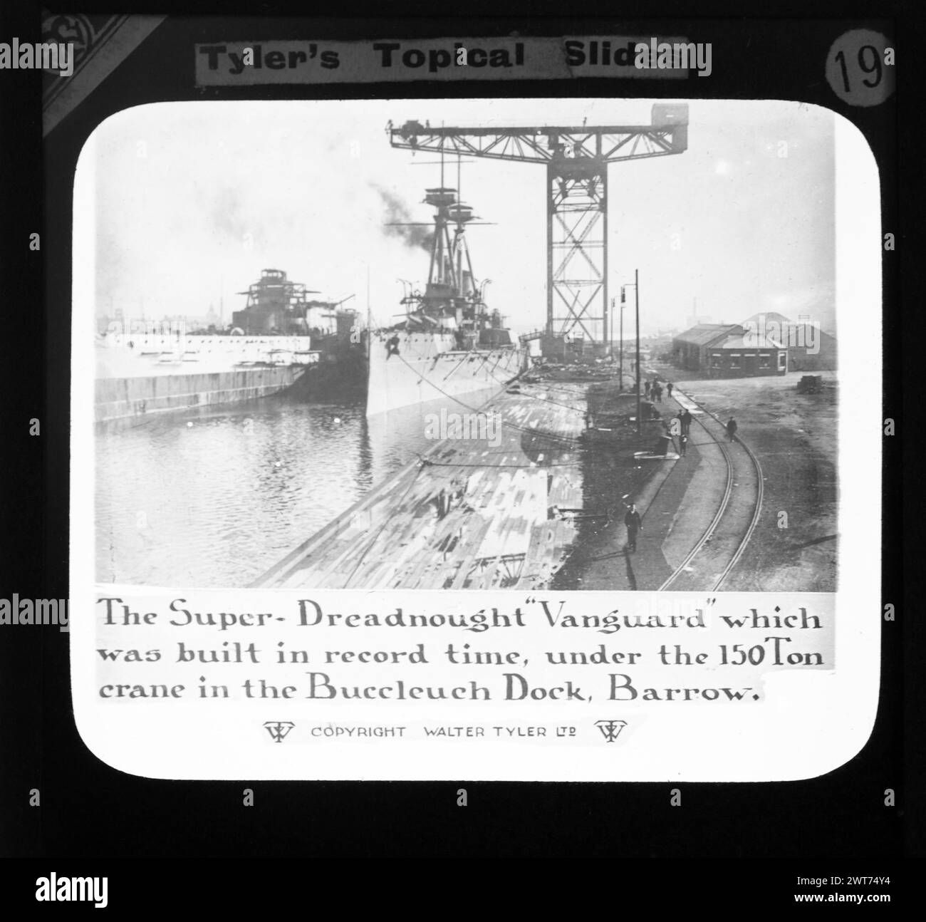 The Super-Dreadnought 'Vanguard' which was built in record time, under the 150 ton crane in the Buccleeuch Dock, Barrow, Walter Tyler Ltd magic lantern slide HMS Vanguard 1909 Stock Photo