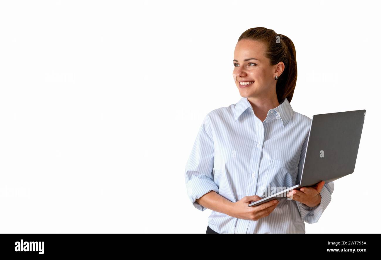 Isolated young businesswoman stands with laptop and smiles. Stock Photo