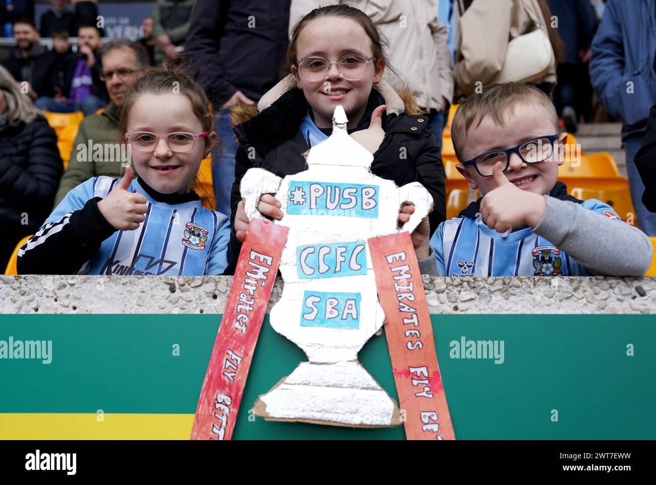 Coventry City fans Gracie May, Bella Rose and Jacob holding a