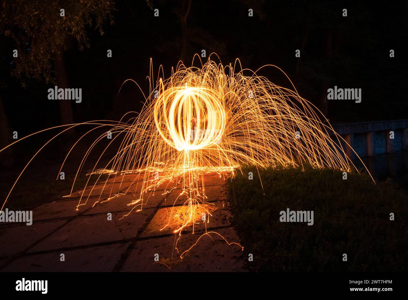 spinning the steel wool in a park. Sparks flying out in all directions ...