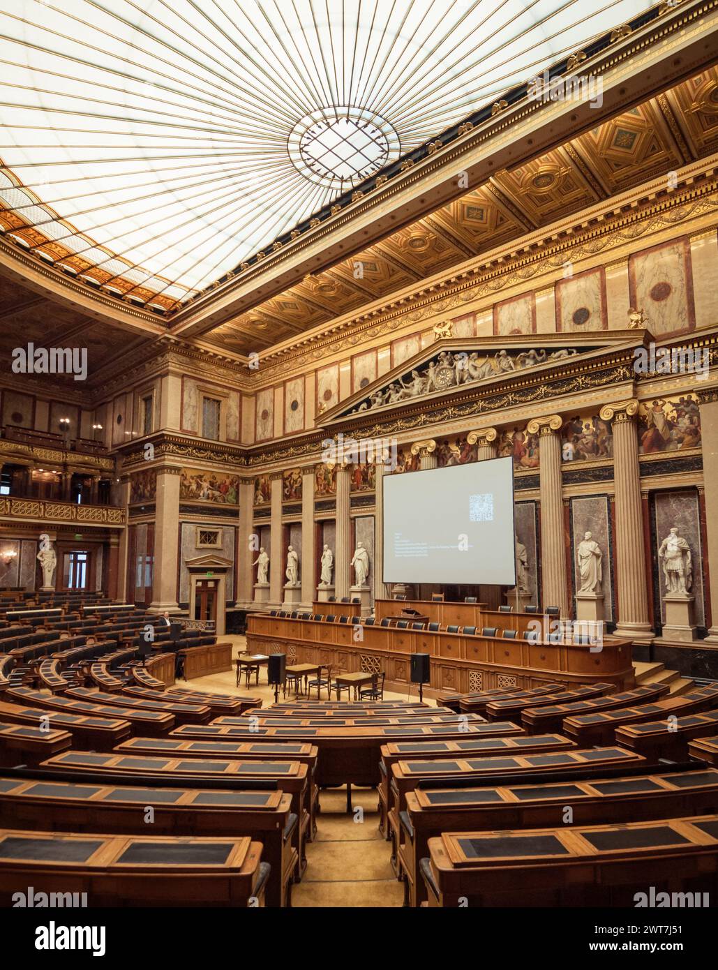 Debating Chamber of the former House of Deputies of Austria. Interior Austrian Parliament Building. Greek Revival architecture with statues & columns. Stock Photo