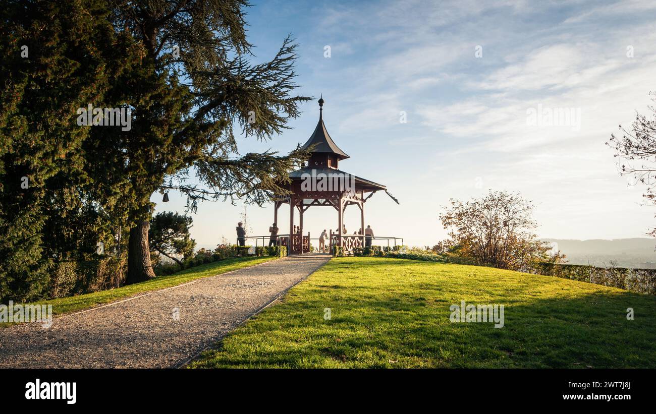 path leading to a gazebo on Schlossberg hill. Chinese pavilion on top of the mountain - viewpoint overlooking Graz city and Styrian alps. Stock Photo