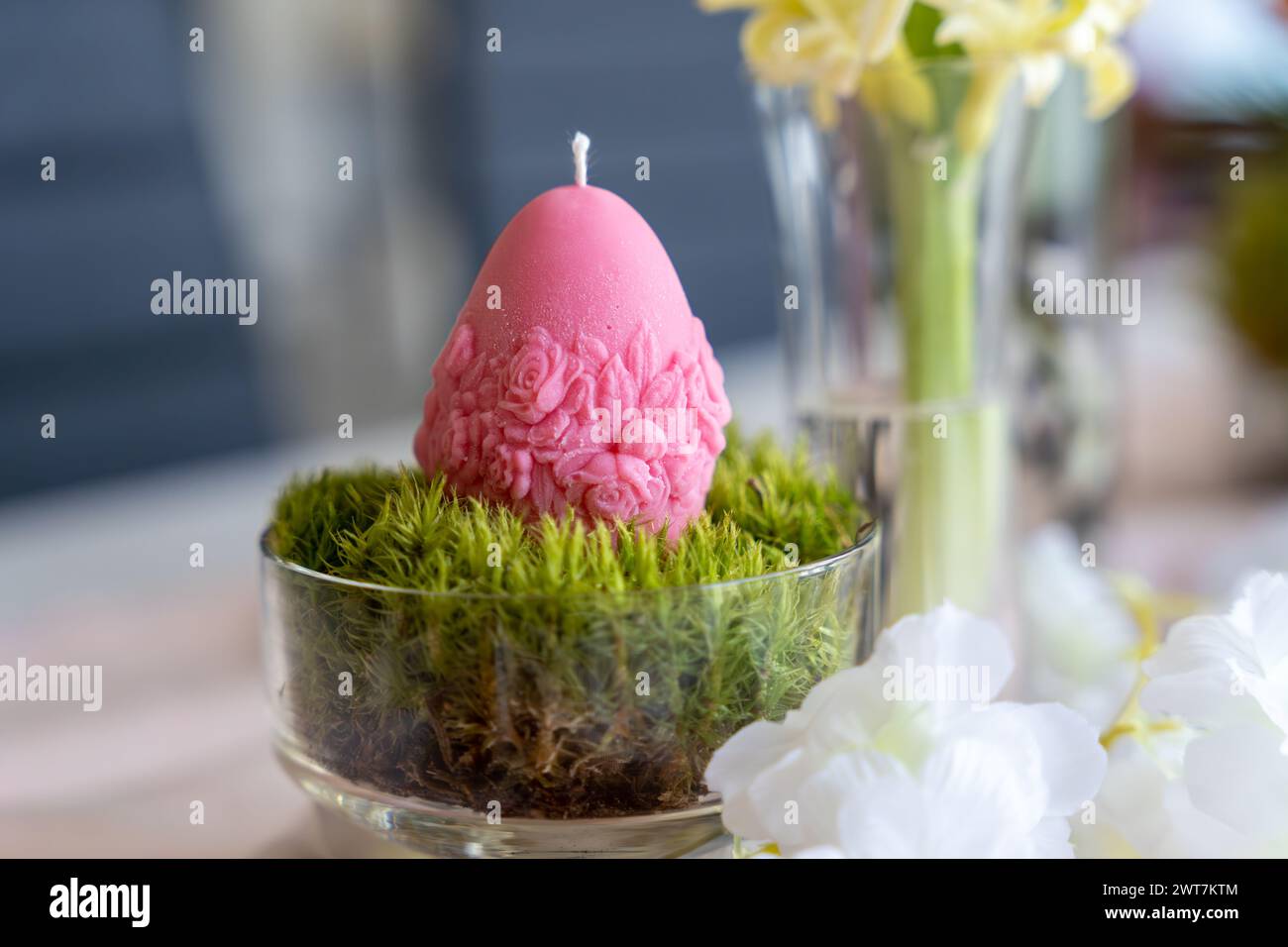 Colorful easter egg soy wax candle. Spring background Stock Photo