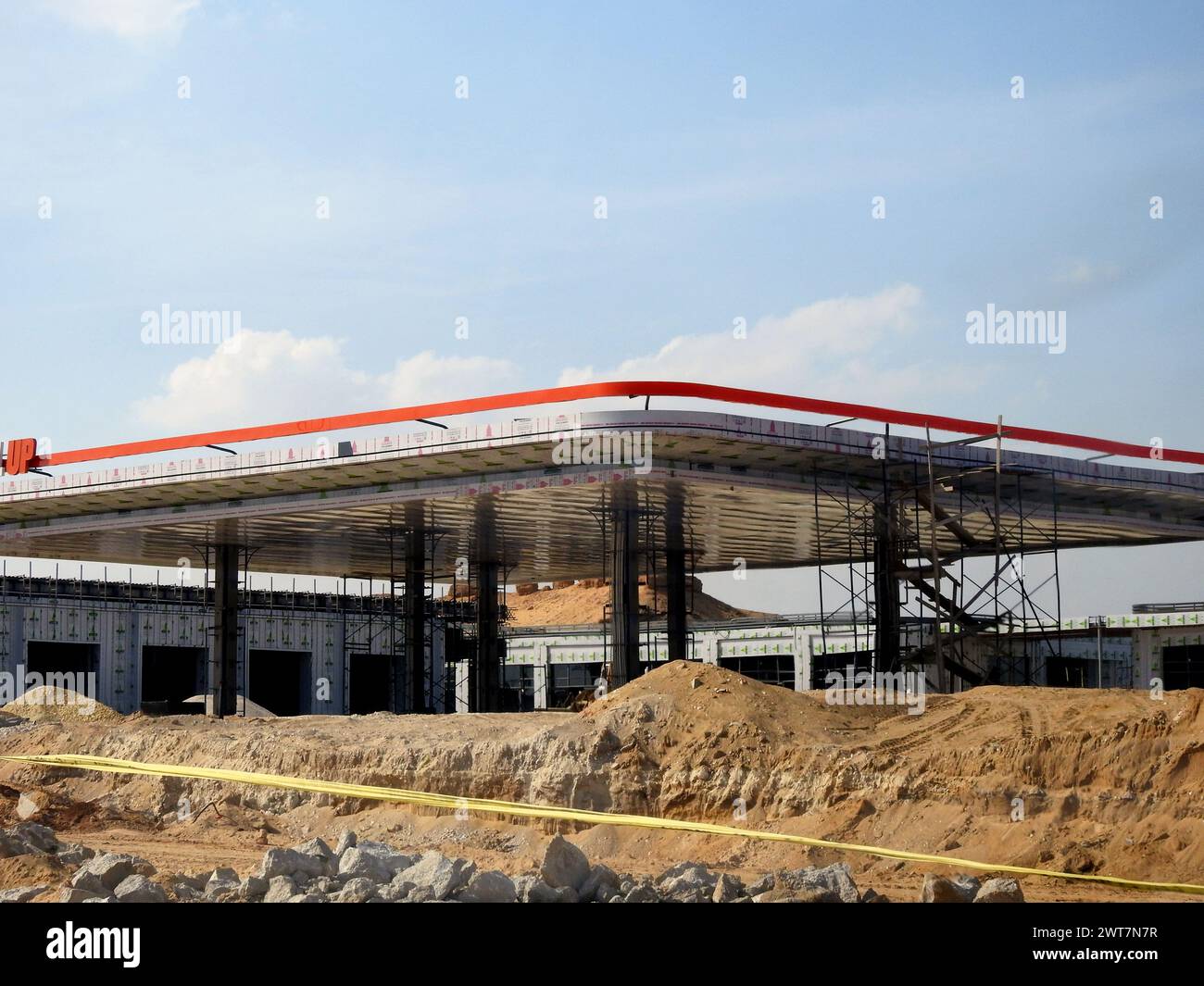Giza, Egypt, March 15 2024: a fuel gas and oil station under construction, a petrol gas station with concrete columns being processed on the ring road Stock Photo