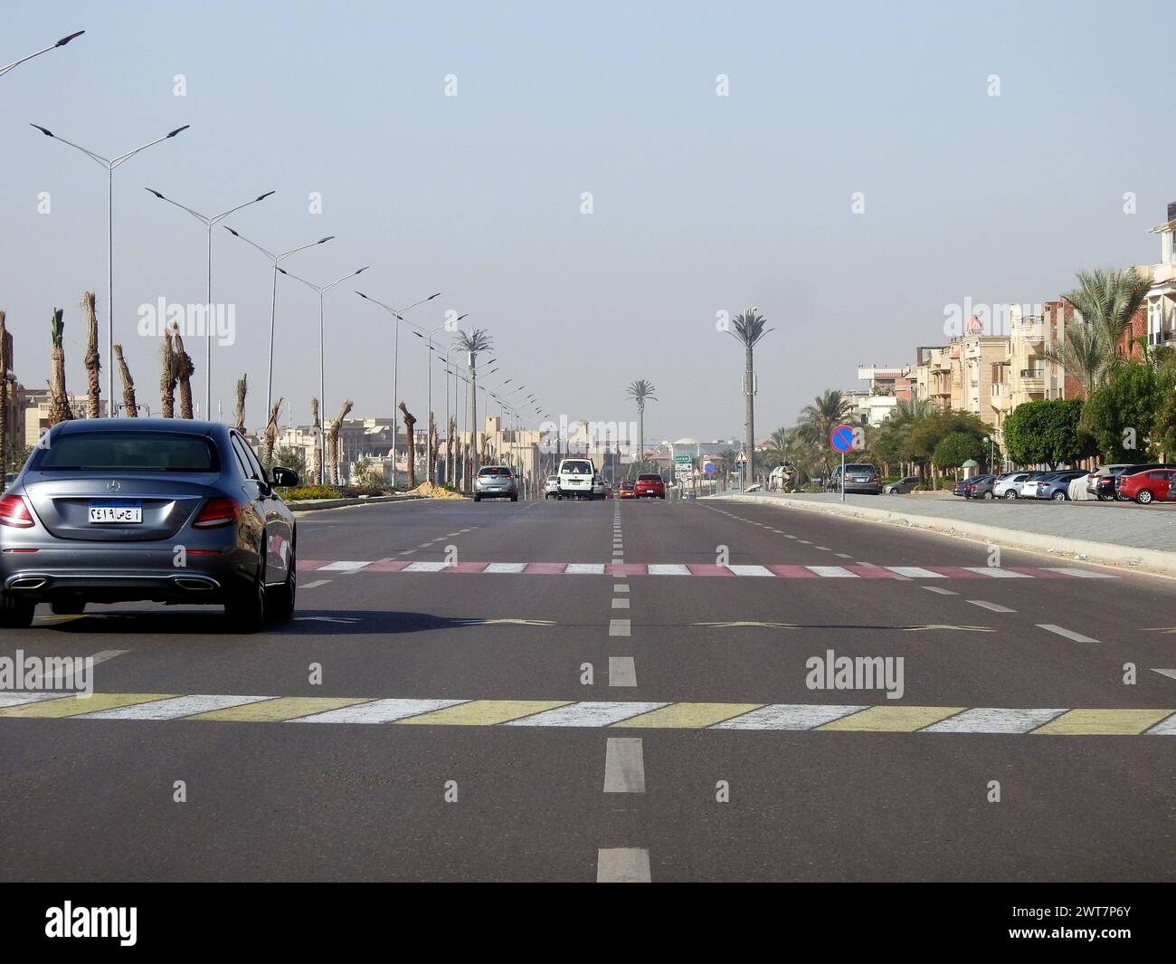 Cairo, Egypt, December 14 2022: A road sign on the asphalt instructing vehicles to slow down, pedestrian crossing ahead. Sign indicating crossing ahea Stock Photo